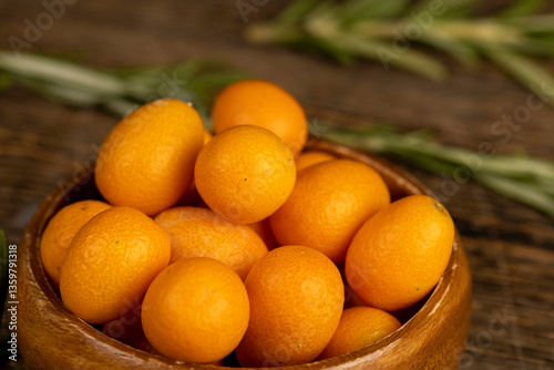 Fototapeta Naklejka Na Ścianę i Meble -  fresh orange kumquat fruits and green spices rosemary