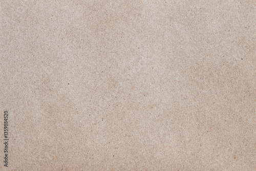 Close-up of natural paper texture in soft beige tone with visible fibers and organic pattern. Concept of eco background, craft surface and design material