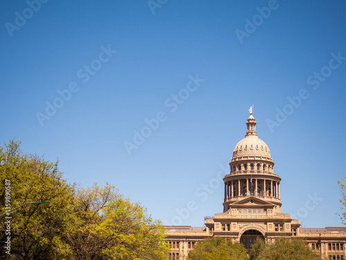 Austin Texas State Capitol Building with American flag and Texas flag