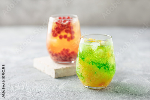 Glasses of homemade fruit lemonade with popping boba or bubble pearls. Trendy summer drink