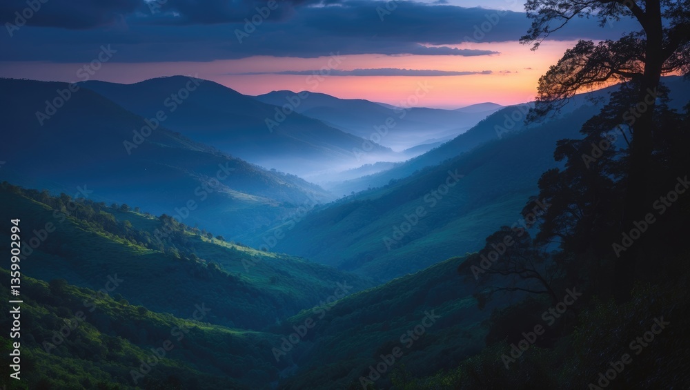 Obraz premium View of the valley above the verdant hills of the National Park at dusk.
