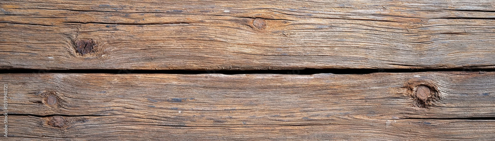 Fototapeta premium Old wooden surface with visible knots and grain texture, showcasing natural weathering