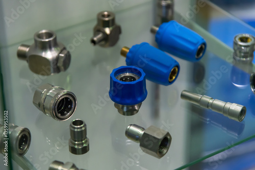 Display of various metal and plastic fittings at an industrial trade show
