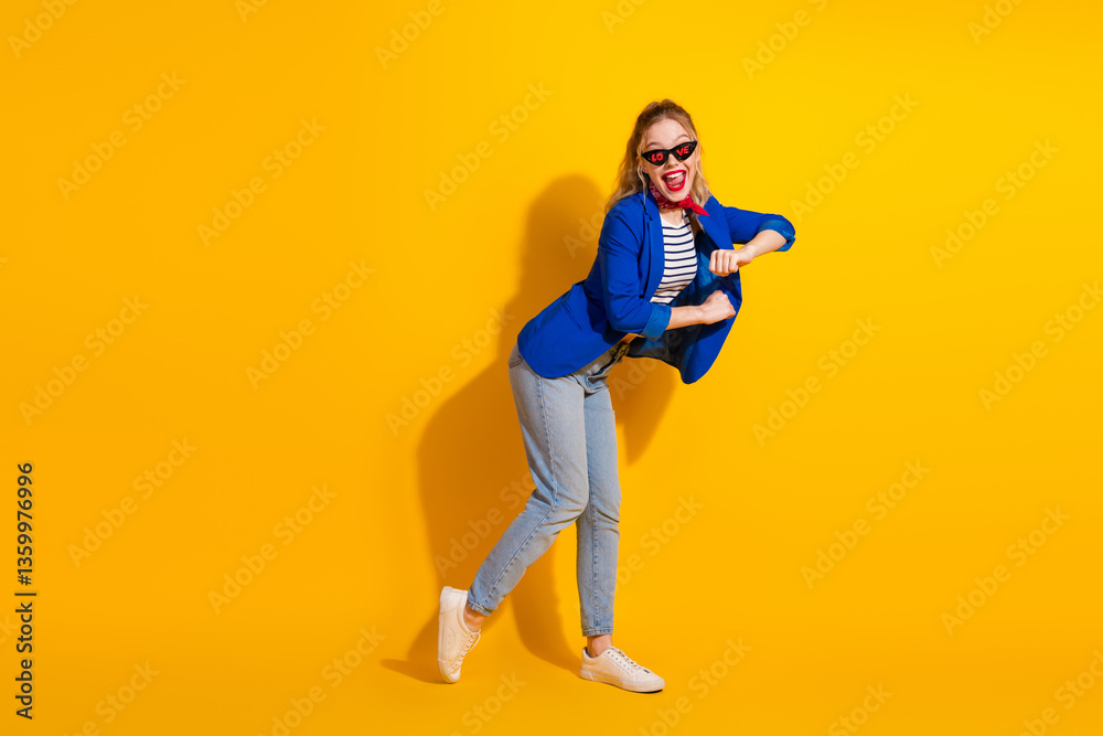 Stylish young woman wearing trendy outfit and dancing joyfully against a vibrant yellow background Stylish young woman wearing trendy outfit and dancing joyfully against a vibrant yellow background