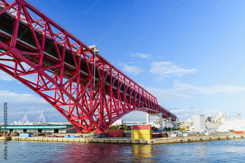 Minato Bridge in Osaka.the symbol of Osaka Harbor, Red big bridge in Osaka, the largest truss bridge in Japan. Minato Bridge in Osaka.the symbol of Osaka Harbor, Red big bridge in Osaka, the largest truss bridge in Japan.