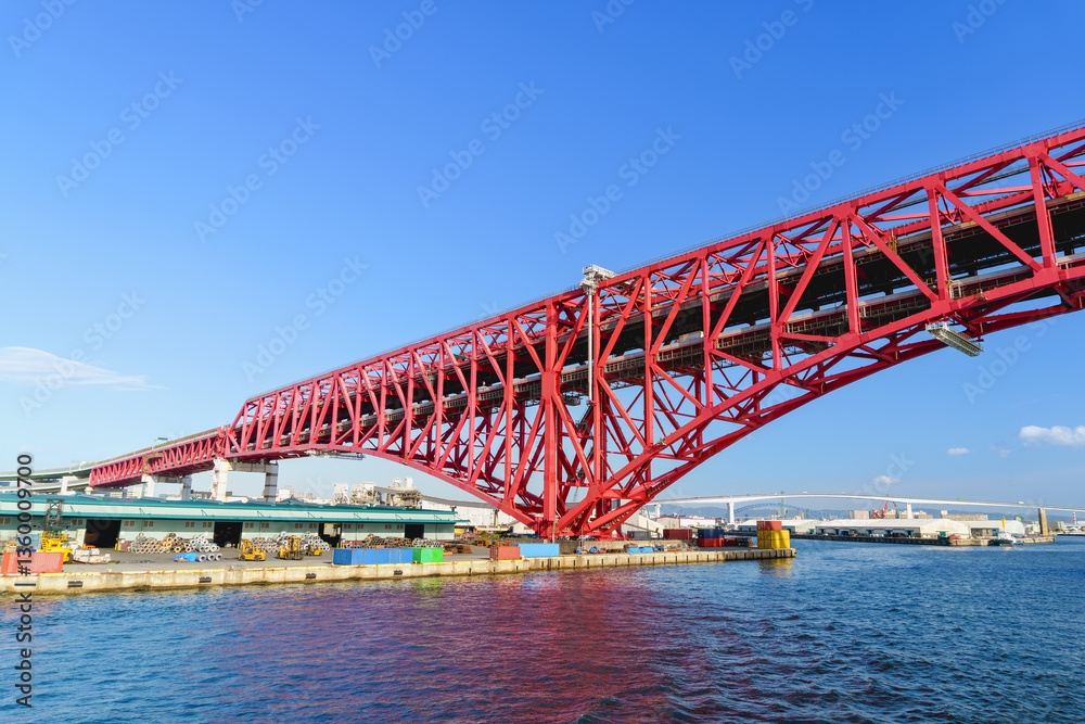 Naklejka premium Minato Bridge in Osaka.the symbol of Osaka Harbor, Red big bridge in Osaka, the largest truss bridge in Japan.
