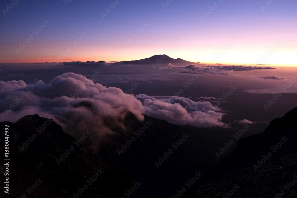 View of Kilimanjaro at sunrise while trekking Mount Meru, a volcano in Tanzania. Arusha National Park
