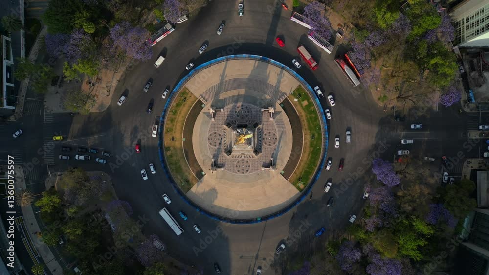 Mexico city Angel de la independencia landmark in downtown, spring with purple flowers jacarandas in paseo de la reforma av