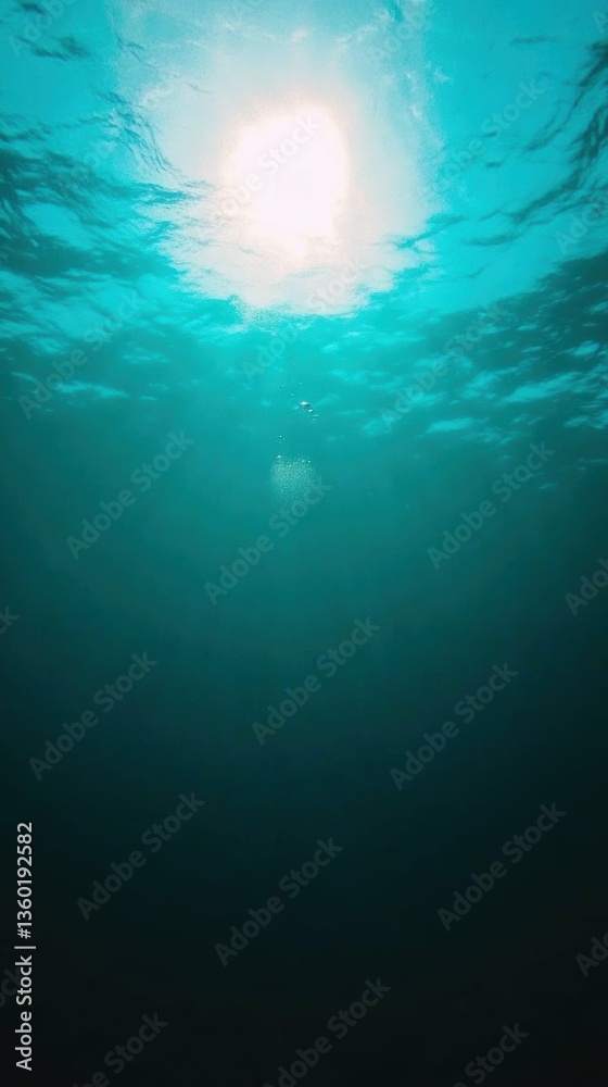 Tranquil underwater scene with air bubble rising toward sunlight Tranquil underwater scene with air bubble rising toward sunlight