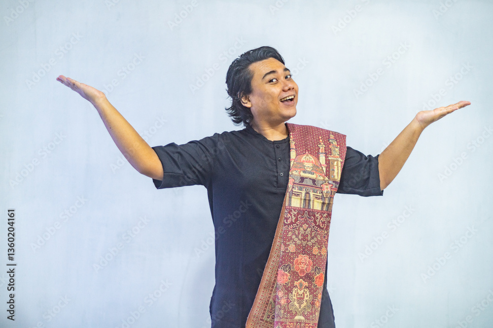 Asian Muslim men pointing to the copy space beside her, isolated by white background. Ramadan and Eid Mubarak concept.