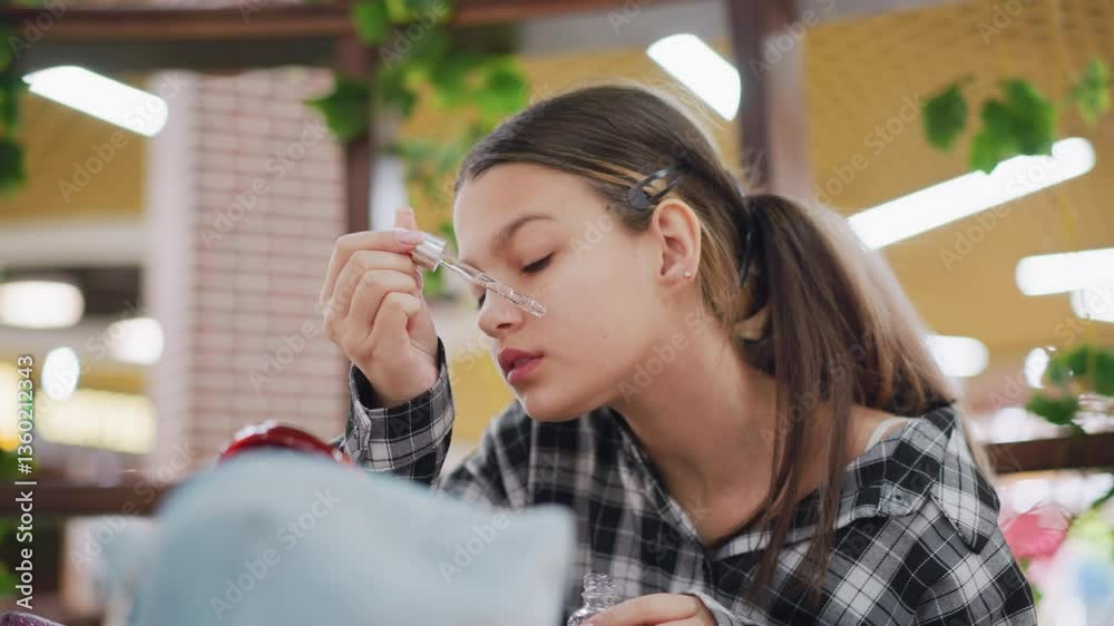 Young lady carefully applying serum under her eye using dropper, focused expression, smooth skin, and natural beauty highlight self-care routine warm lighting and blurred background Young lady carefully applying serum under her eye using dropper, focused expression, smooth skin, and natural beauty highlight self-care routine warm lighting and blurred background