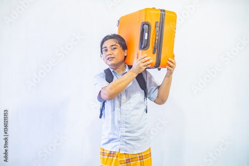 Portrait Asian muslim man carrying suitcase . Concept Going home for Eid Mubarak. Isolated image on white background