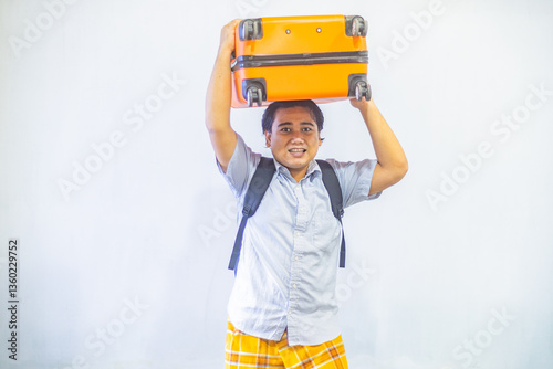 Obraz na płótnie Portrait Asian muslim man carrying suitcase . Concept Going home for Eid Mubarak. Isolated image on white background w salonie