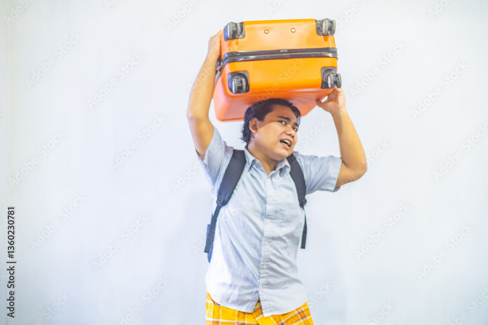 Portrait Asian muslim man carrying suitcase . Concept Going home for Eid Mubarak. Isolated image on white background