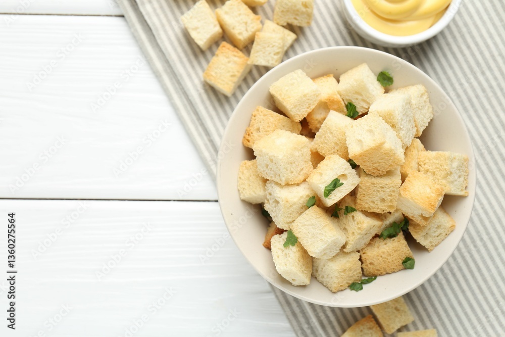 Delicious crispy croutons with parsley and sauce on white wooden table, flat lay. Space for text Delicious crispy croutons with parsley and sauce on white wooden table, flat lay. Space for text