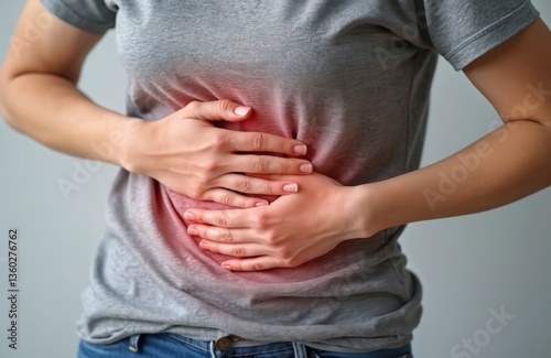 Woman with hands on stomach suffers abdominal pain. Concept of stomachache, gastritis, indigestion, bowel issues, digestive problems. Health, medical, medicine concepts. Healthcare, illness. Closeup