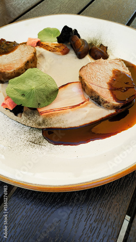 Obraz na płótnie Slices of roasted pork tenderloin with mushrooms and creamy sauce, gourmet dish at red lhota castle w salonie