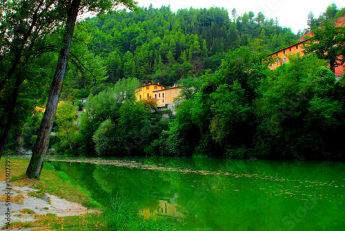 Konstfotografi Gorgeous scene from Fossombrone with the Metauro river's emerald waters mirrorin