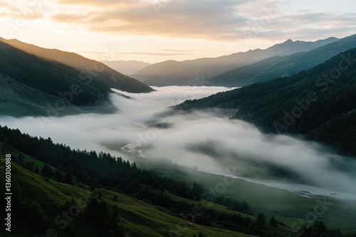 Dawn in the mountains, fog over the valley, the sun breaks through the clouds. The greatness of nature, the summer magic.
