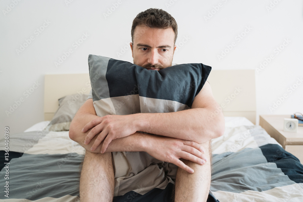 Fototapeta premium Sad and lonely man seated on his bed