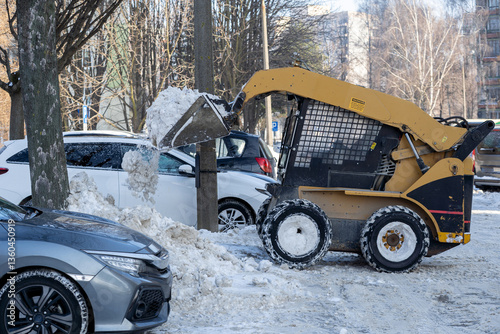Snow Removal Equipment Actively Clearing Snow from a Parking Lot During Winter Weather