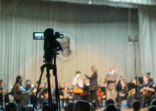 03/24/2025 Russia Udmurt Republic, Izhevsk. Musical college. Concert of students of music college. Recording of the orchestra concert broadcast on camera with focus on classical musicians photo