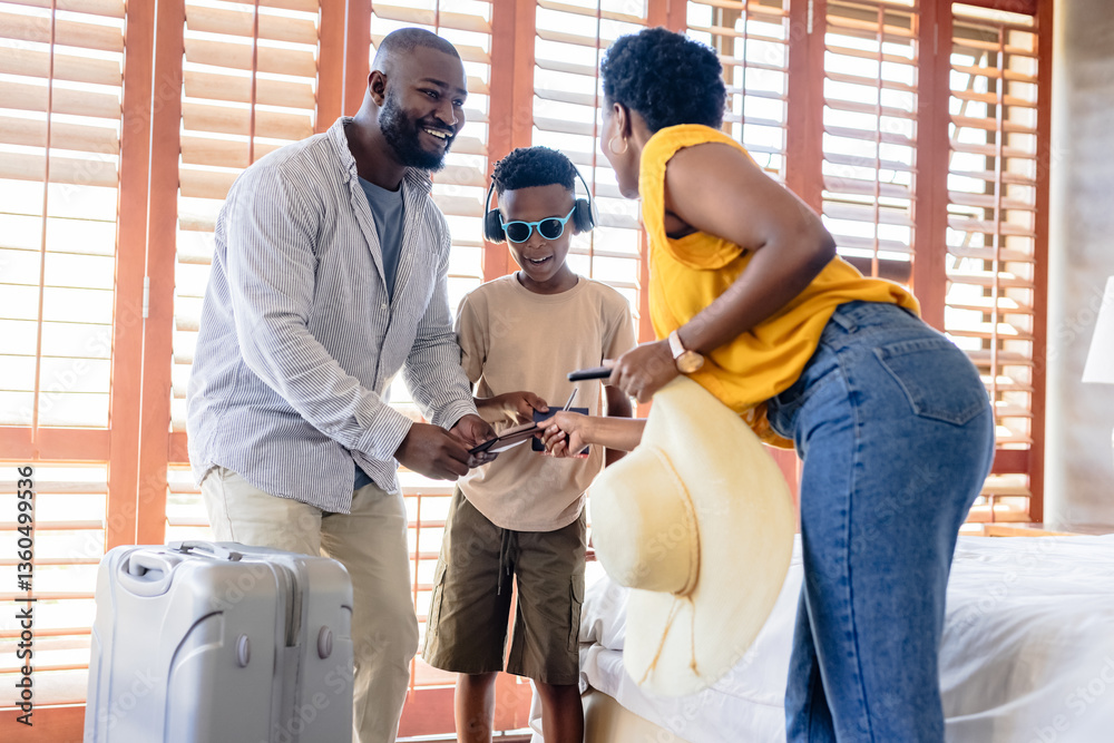 Packing suitcase for vacation, African American family smiling together at home Packing suitcase for vacation, African American family smiling together at home