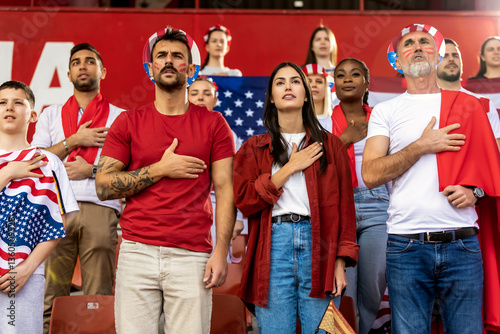 American football,  soccer fans singing anthem at the stadium.