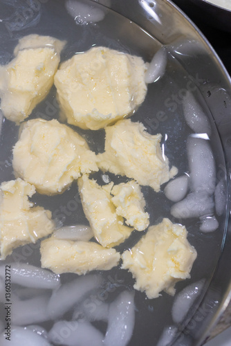 Butter being rinsed and chilled in an ice water bath