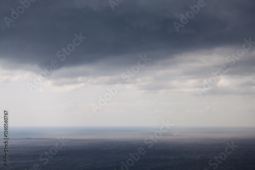 Tableau sur toile A stunning, mesmerizing view of the seascape, the dark black sea and cumulus thunderstorm large clouds and the birth of a waterspout in the hot, sultry summer the city of Anapa