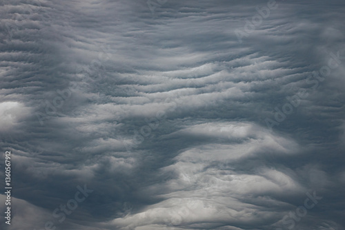 Cuadro en lienzo A dramatic display of undulatus asperatus clouds forms wavy, textured layers across the sky, creating a surreal and turbulent atmosphere