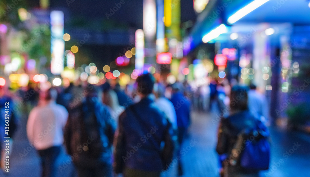 Fototapeta premium Personas variadas caminando con desenfoque de movimiento por por la noche una calle de ciudad iluminada con ambiente cálido