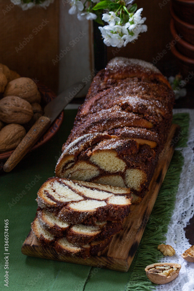Traditional Easter bread with chocolate and nut filling on a wooden background.