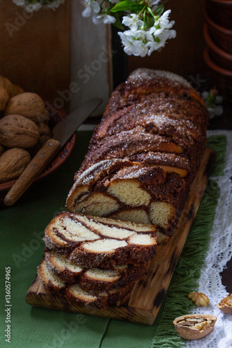 Obraz na płótnie Traditional Easter bread with chocolate and nut filling on a wooden background. w salonie
