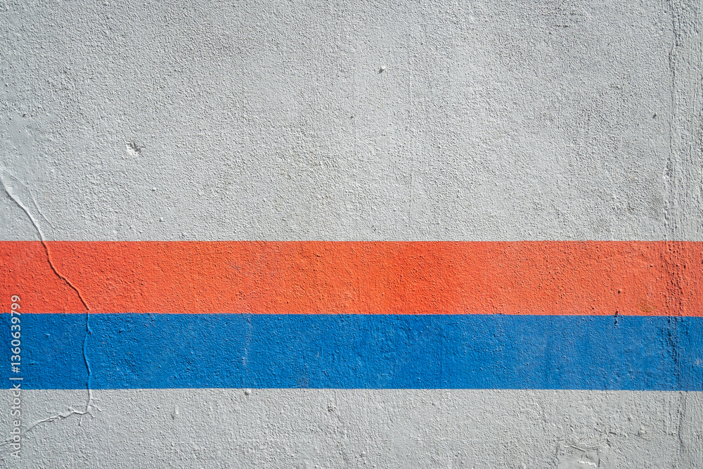 Fototapeta premium An abstract image of a wall with a horizontal red and blue line against a gray background