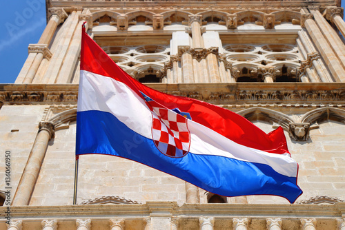 Obraz na płótnie Croatian flag blowing in the wind on the bell tower of The Cathedral of St. Lawrence, landmark in Trogir, Croatia. w salonie