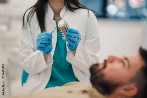 Dentist preparing dental amalgam filling for patient in clinic