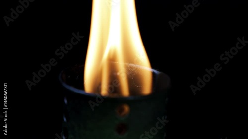 Macro Torch burning, smoldering small flame fuse wick. 