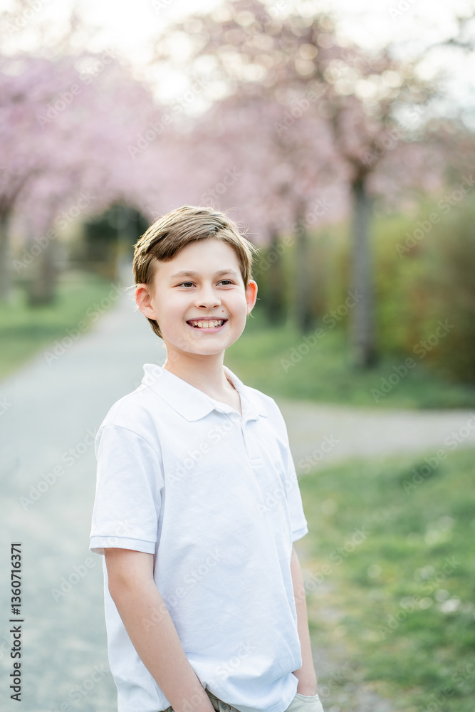 Portrait of cute 10 year old boy in pink blooming sakura. Portrait of cute 10 year old boy in pink blooming sakura.