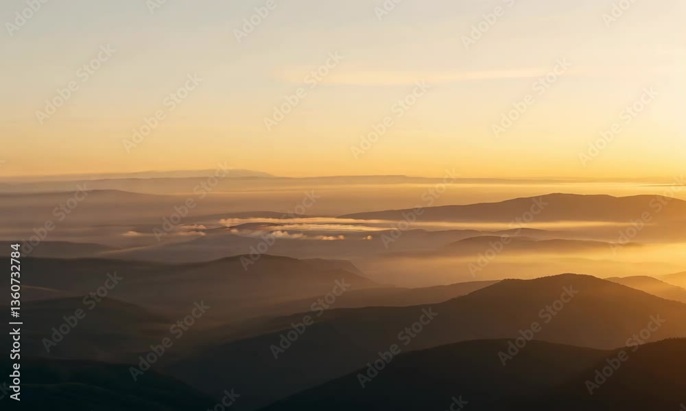 Man standing on cliff overlooking vast mountain sunrise Man standing on cliff overlooking vast mountain sunrise
