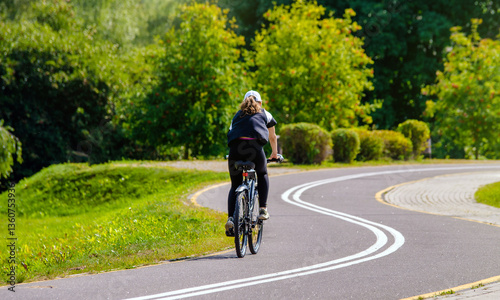 Wallpaper Mural Cyclist ride on the bike path in the city Park
 Torontodigital.ca