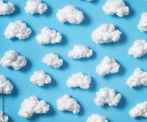 Pattern of white fluffy clouds made of cotton wool on a blue background