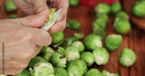 Brussels sprouts preparing, peeling and cleaning using peeling knife, close up
