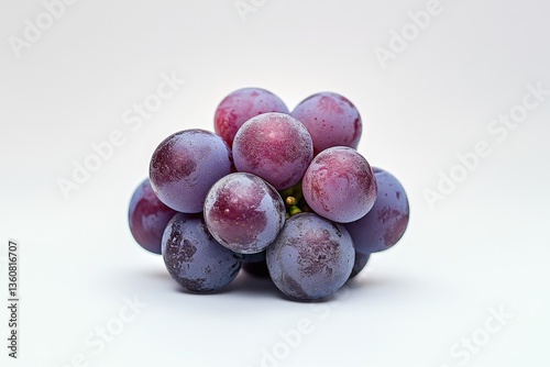 A bunch of ripe purple grapes on a white background