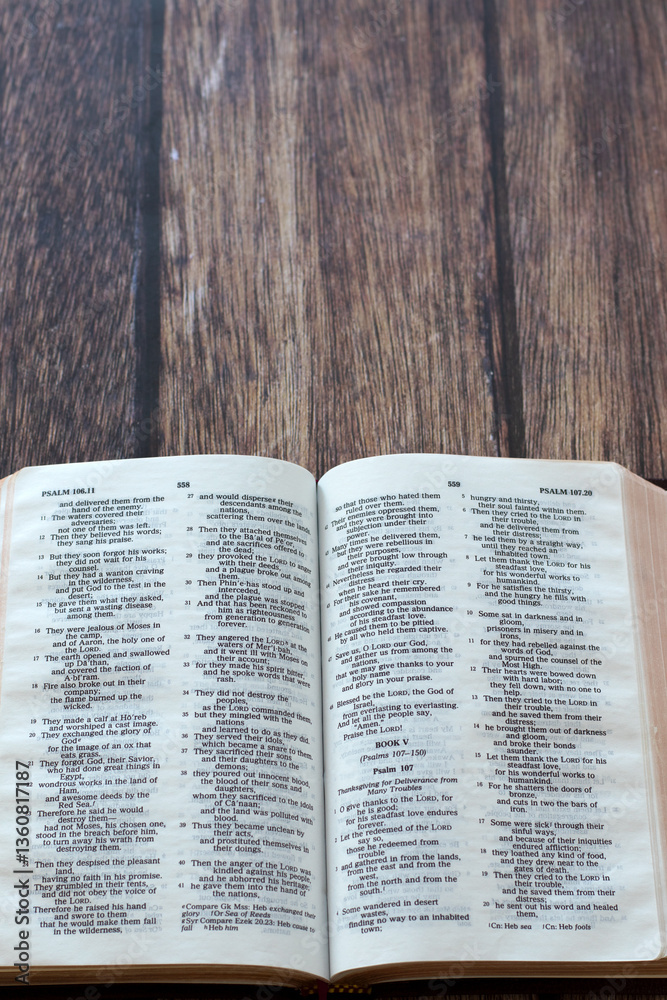 Fototapeta premium Open holy bible book on wooden background. Top view. Copy space. Christian study and reading, biblical concept.