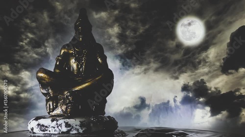 Water drops falling on the surface of the water next to Lord Shiva meditating on a rock against the backdrop of a night sky with clouds and a full moon. Composite 4k timelapse slow motion video.