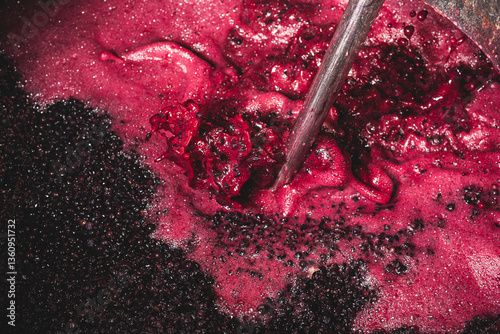 Winemaking in Action: Punching Down the Cap in Red Wine Fermentation