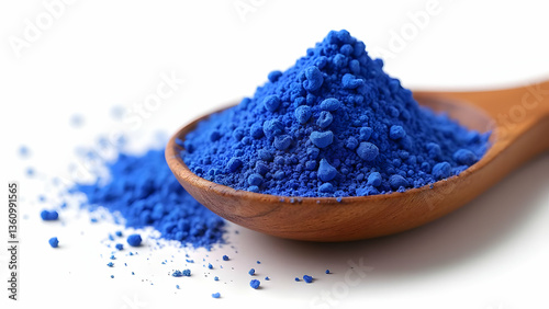 Vibrant Blue Butterfly Pea Flower Powder Exotically Showcased in Unique Wooden Spoon on White Surface