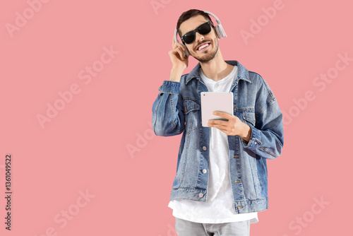 Young bearded man in headph...