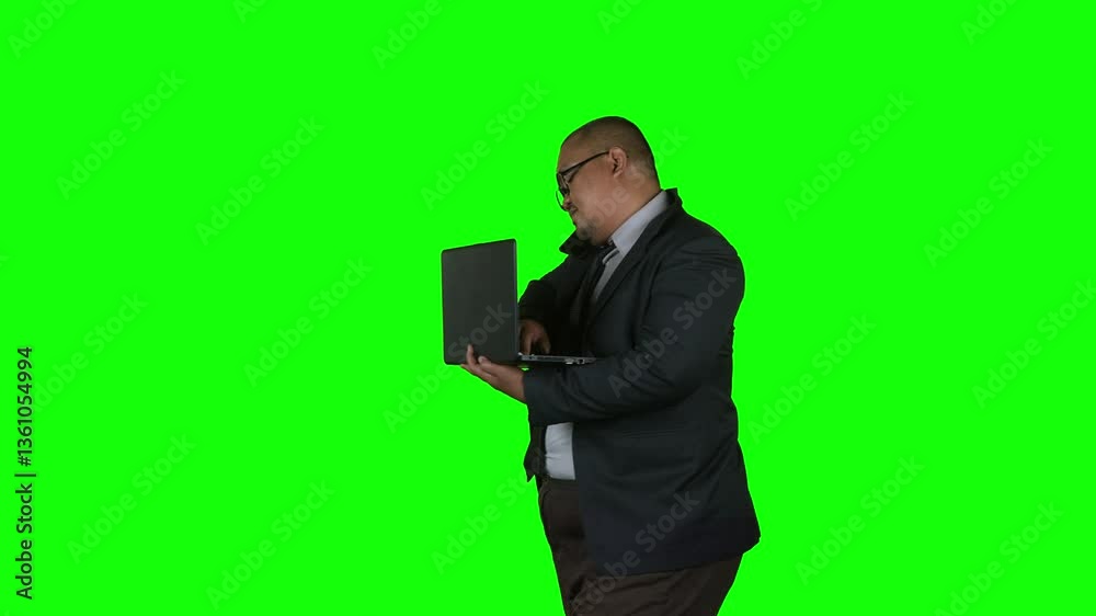 Busy Businessman Checking Time While Working on Laptop with Green Screen Background Busy Businessman Checking Time While Working on Laptop with Green Screen Background